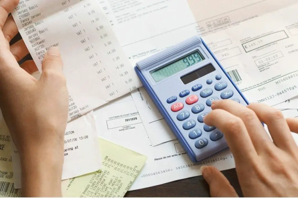 calculator with receipts for irregular expenses to be included in budget to avoid budgeting mistake