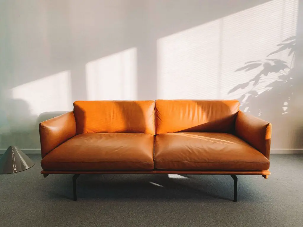 Best selling apps 2-seat orange leather sofa beside wall
