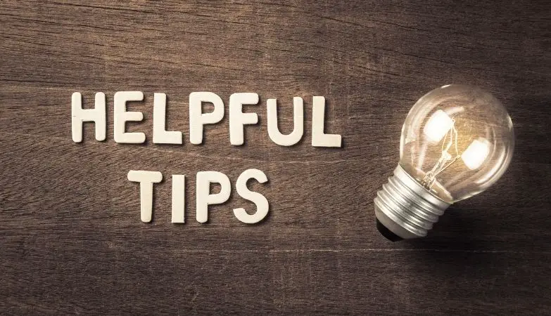 helpful tips with a glowing light bulb on wood texture - 5 tips to succeed with the 30-day savings rule