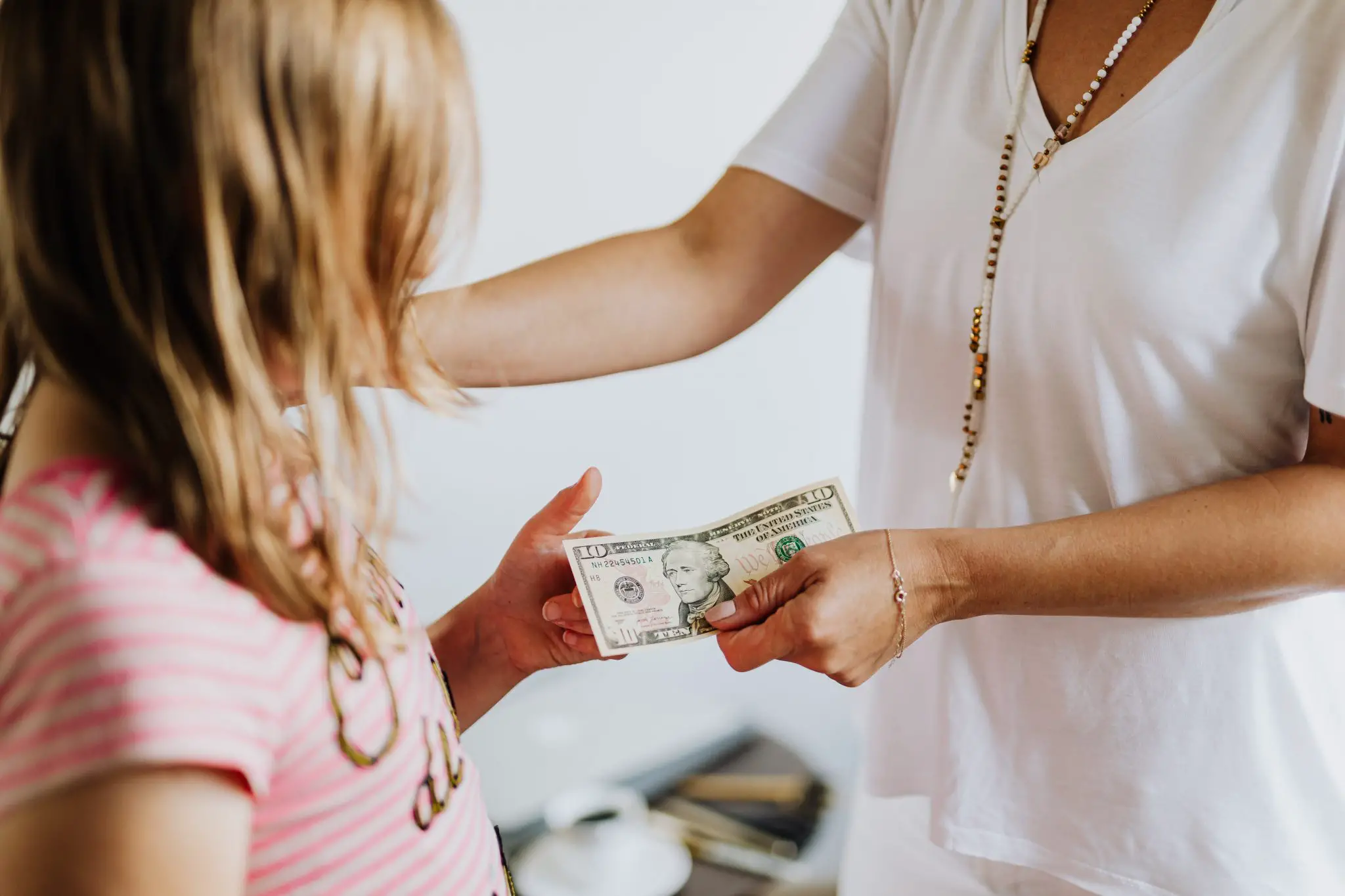 mother giving her child money