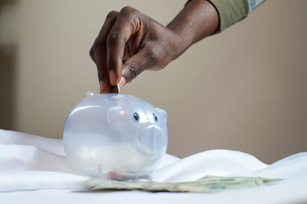 investing for beginners with little money - plastic piggy bank