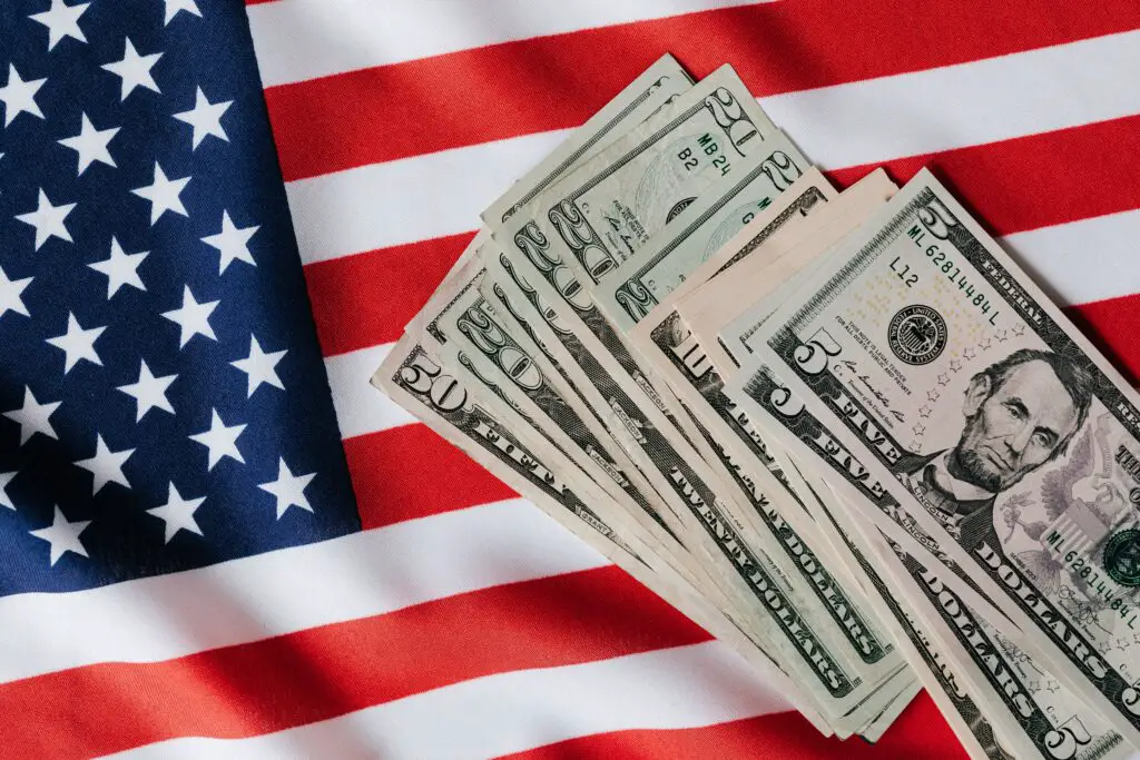 /united-states-flag-and-pile-of-dollar-bills