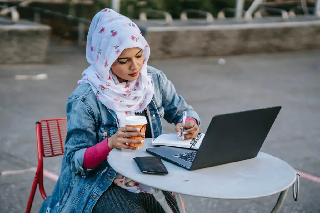 concentrated-muslim-woman-freelancer-working-on-street