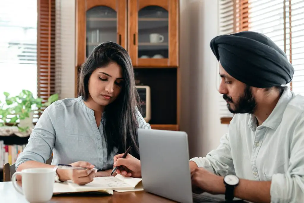 concentrated-coworking-couple-discussing-project-together