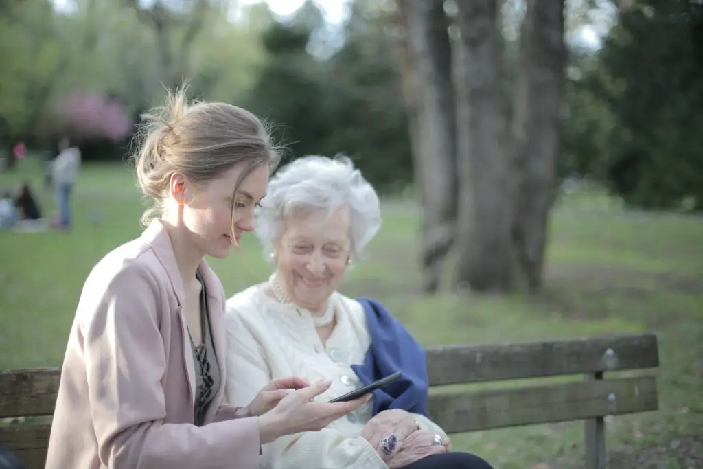 daughter-explaining-elderly-mother-how-using-smartphone