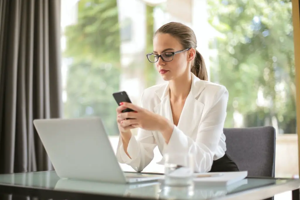 serious-businesswoman-using-smartphone-in-workplace