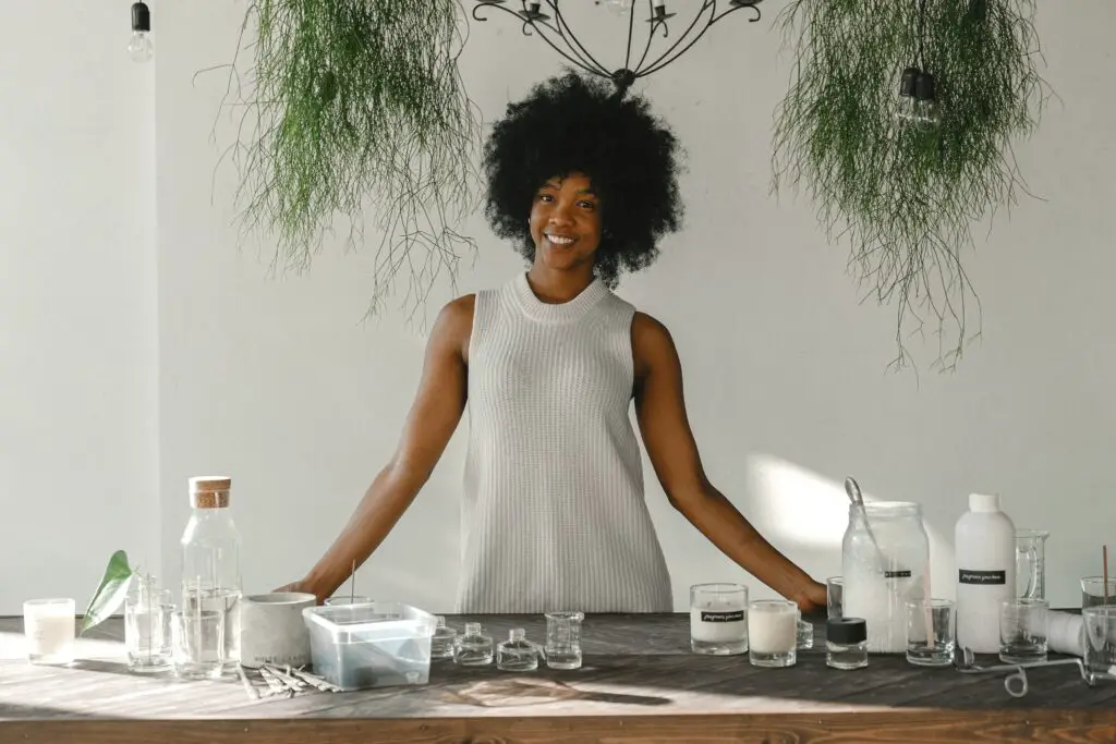 what to do with 50k delighted-black-woman-standing-at-table-in-workshop-for-making-candles