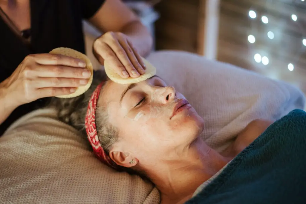 woman-removing-mask-from-face-after-massage