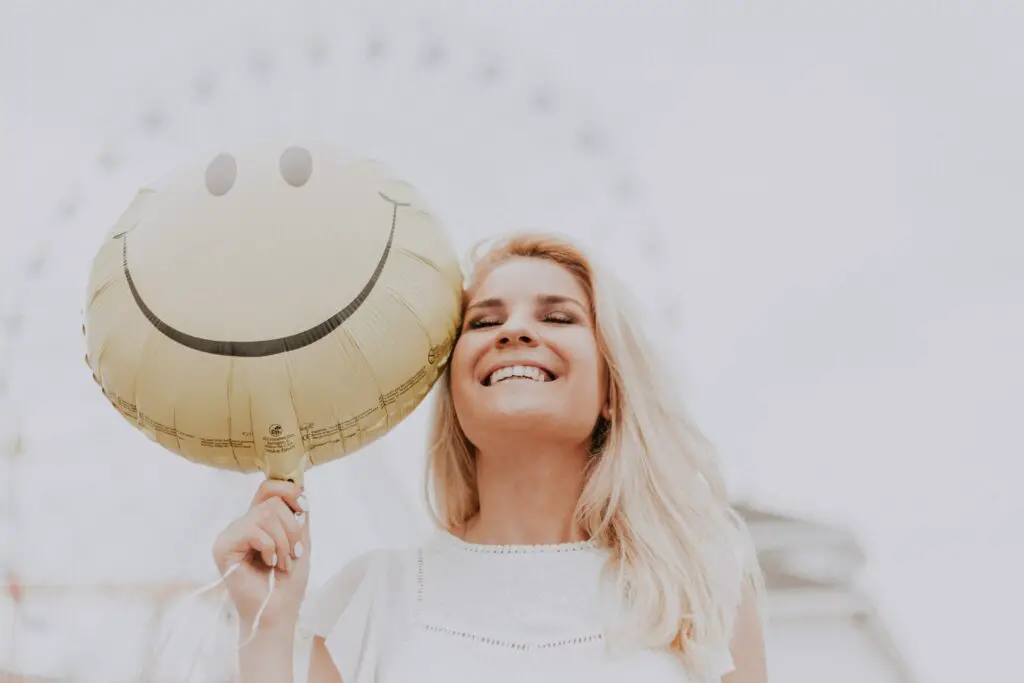 woman-holding-a-smiley-balloon