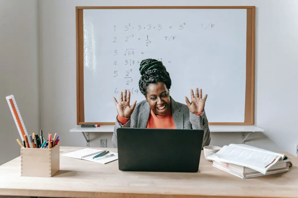 how to make 300 dollars in a day happy-black-woman-using-laptop-for-online-work