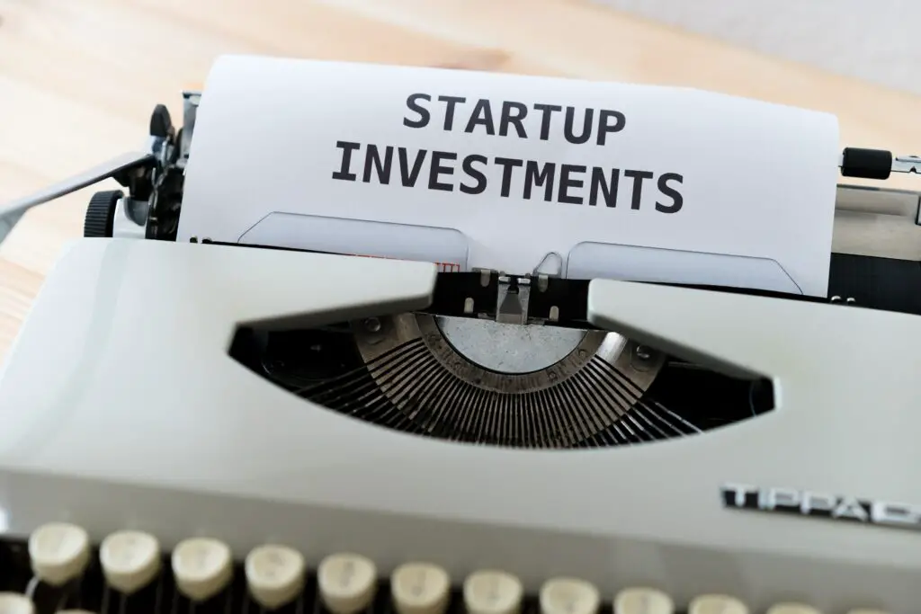 how much is 6 figures- photo of typewriter with written startup investments