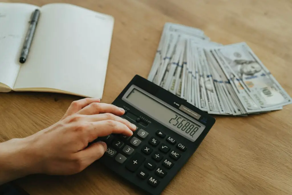 person-holding-black-desk-calculator