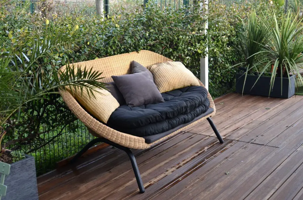 cozy-rattan-sofa-with-cushions-in-tropical-garden-