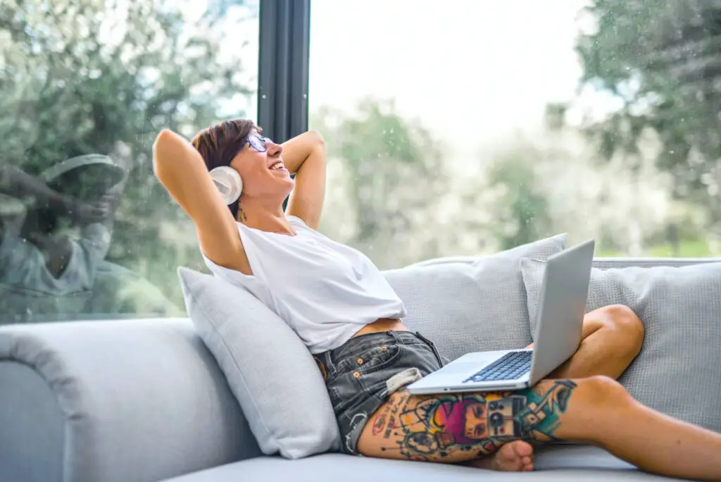 how to make money as a digital nomad woman wearing headphones chill with laptop 
