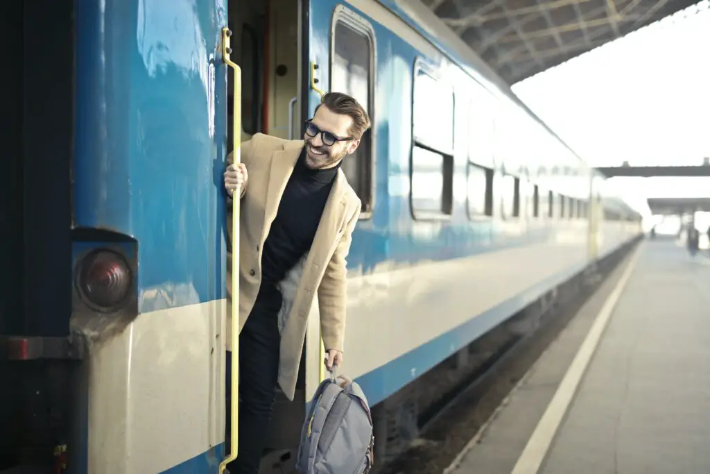 man-wearing-beige-overcoat-inside-train