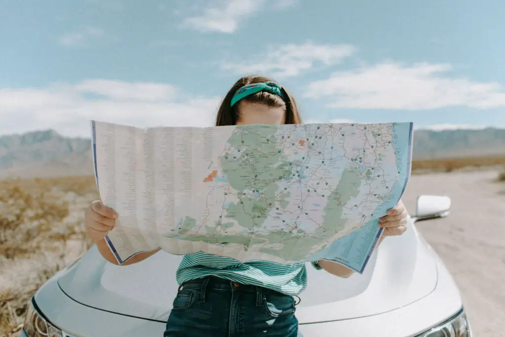 how to budget for travel woman-looking-at-the-map