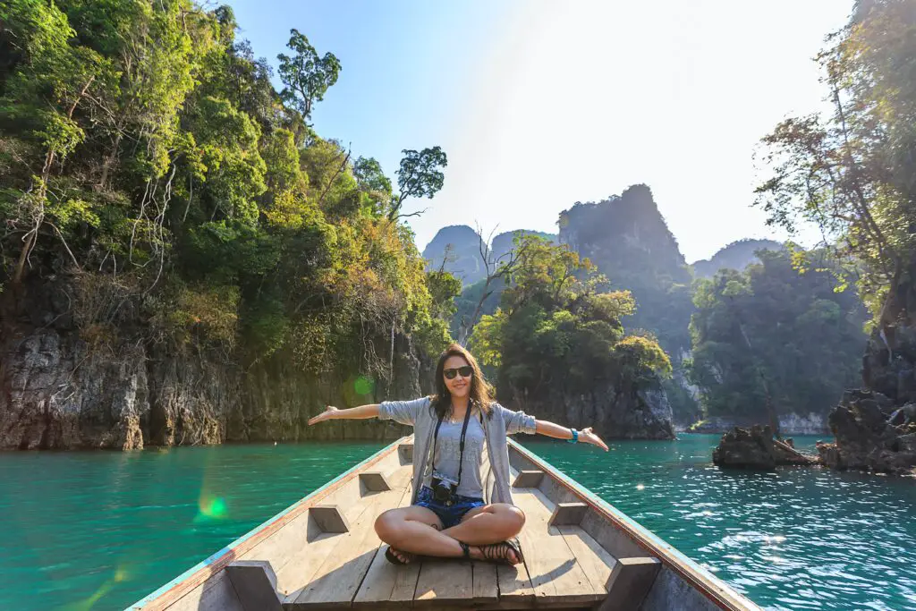 photo-of-woman-sitting-on-boat-spreading-her-arms