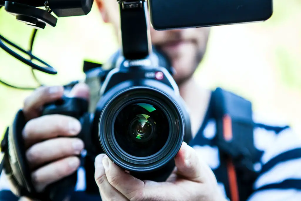 how much money do Youtubers make per view /person-holding-canon-dslr-camera-close-up-photo