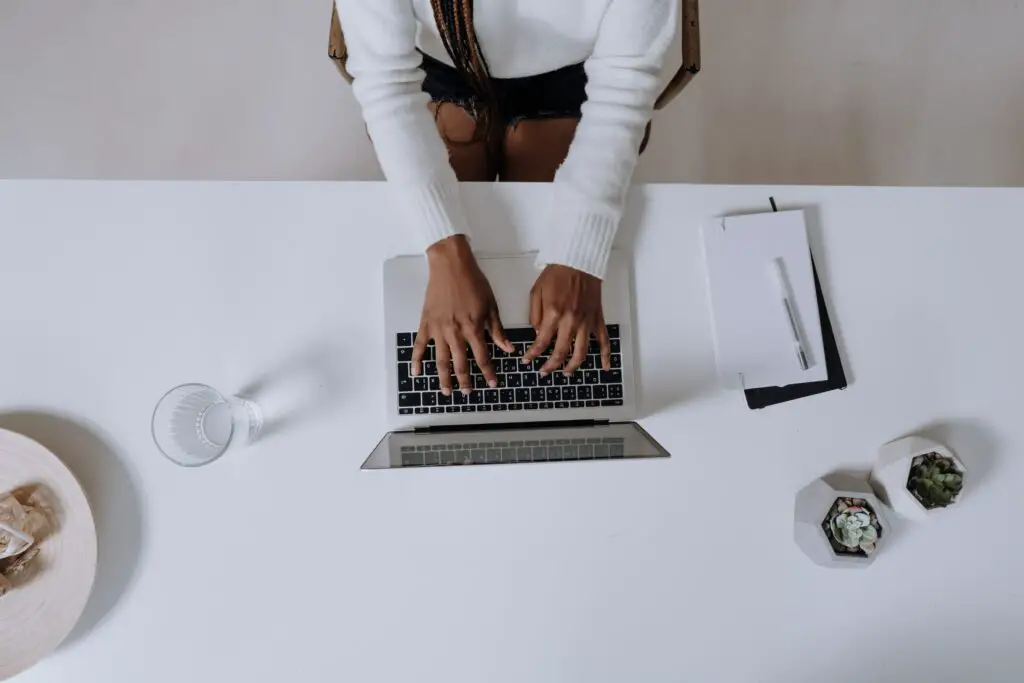 best side hustles for introverts woman-in-white-long-sleeve-shirt-using-macbook-pro