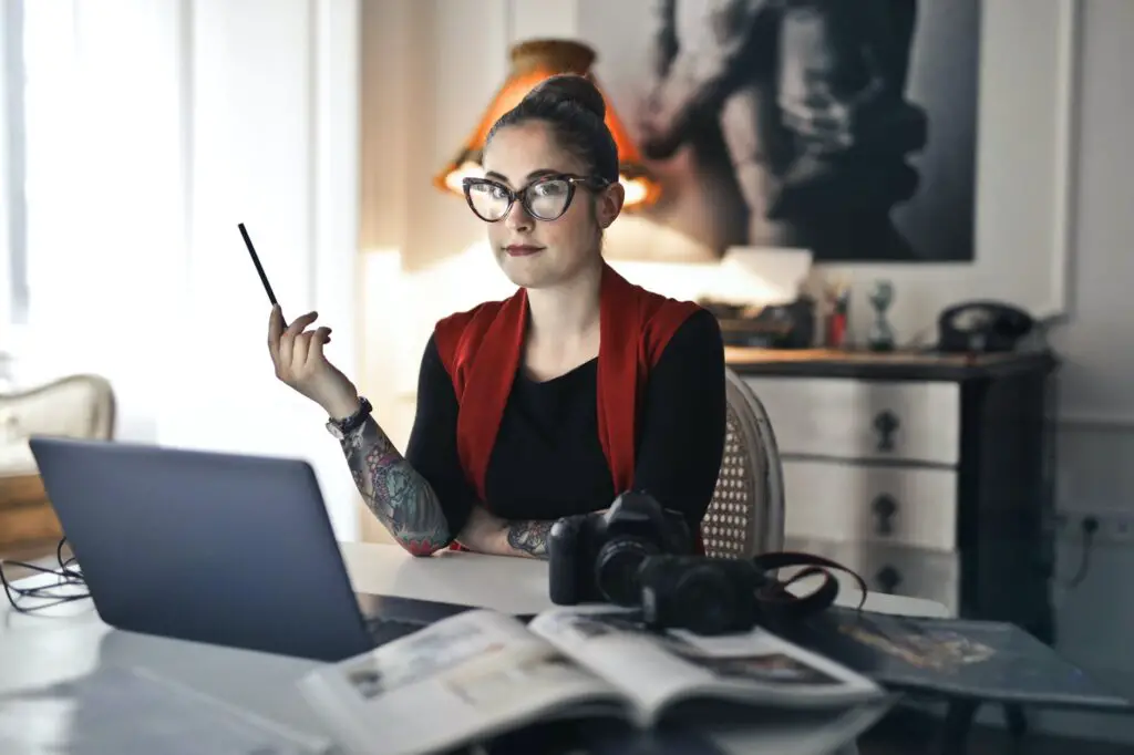 best side hustles for introverts informal-adult-woman-using-laptop-for-working-with-photo-project
