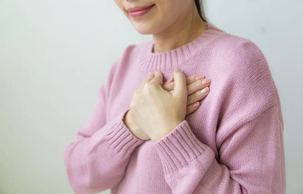 smiling-crop-woman-with-crossed-hands