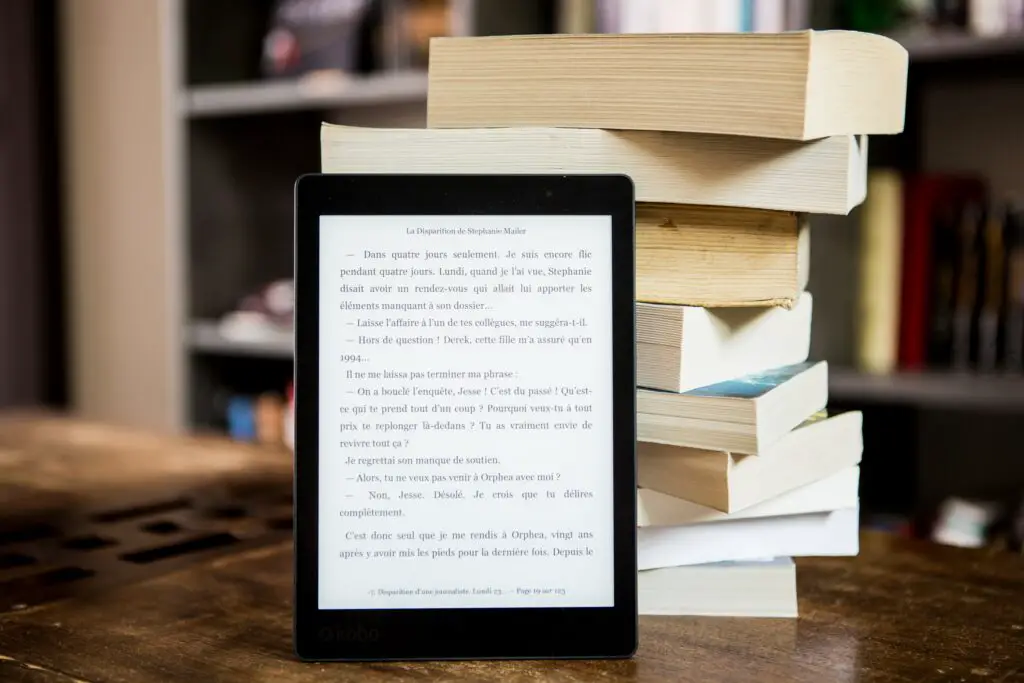 stack of books and kindle e book