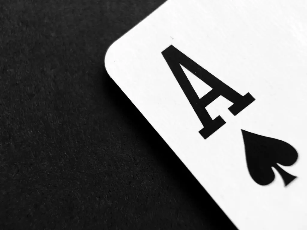 ace-of-spade-playing-card-on-grey-surface