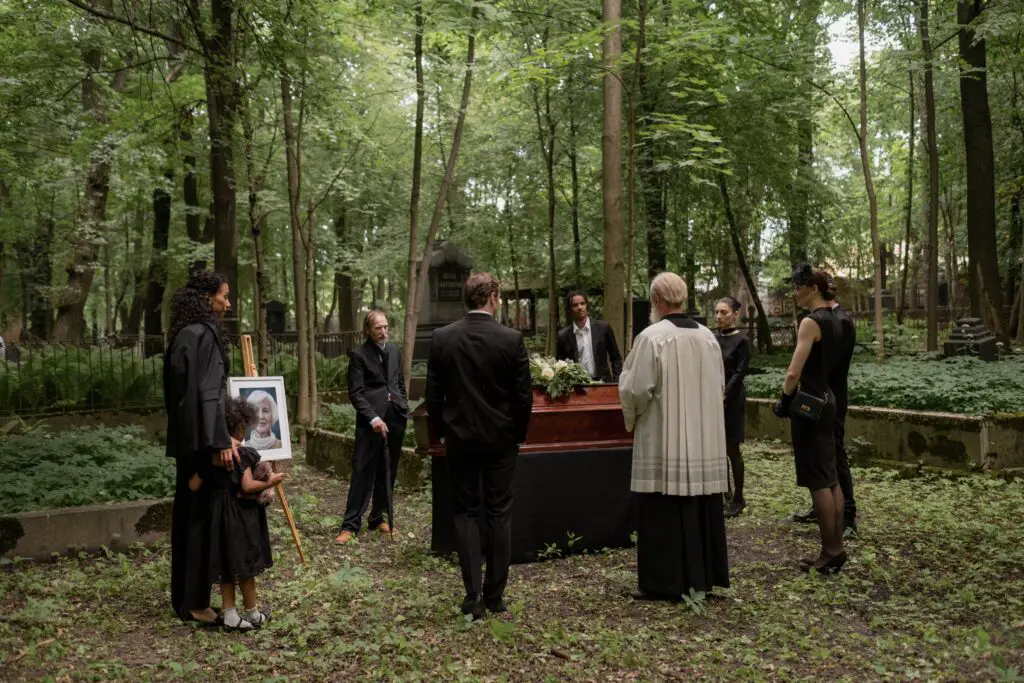 people at the funeral wearing black clothes