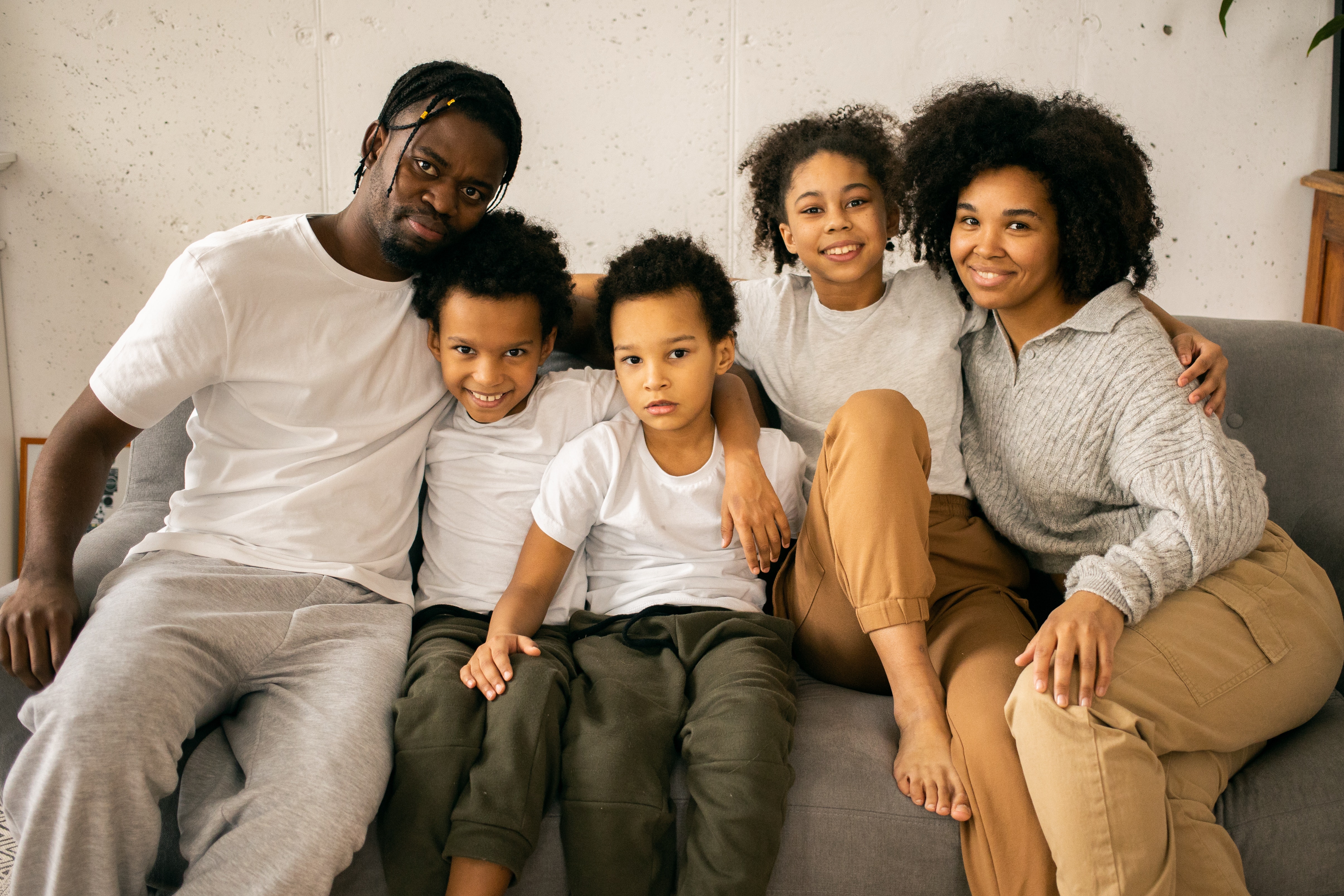 black family happy smiling on couch