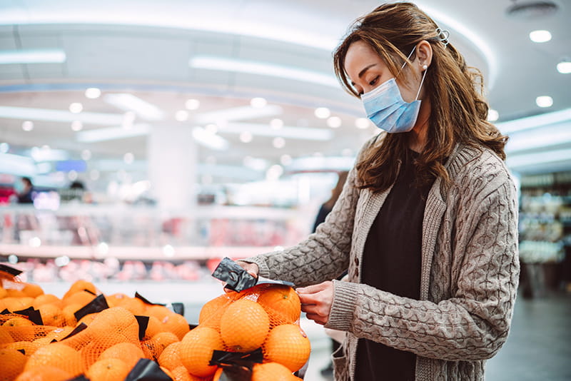woman wearing mask grocery shopping