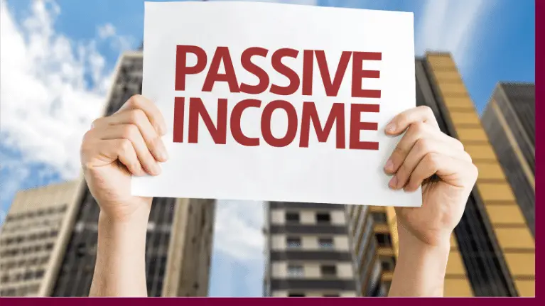 hand raising up a paper saying "passive income"